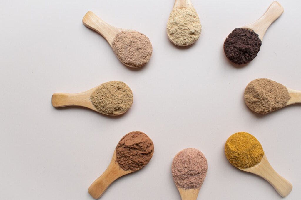 Different protein powder scoops with varying textures - Best chocolate whey